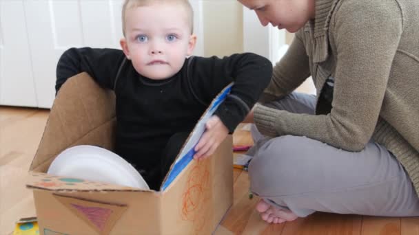 Mom making a spaceship with her toddler boy — Stock Video