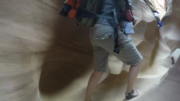 Mother and a newborn hiking slot canyon — Stock Video