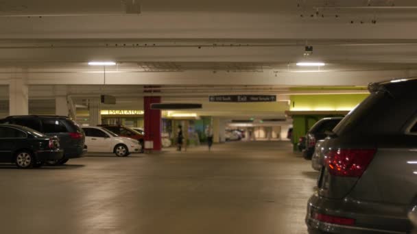 People in an underground parking garage — Stock Video