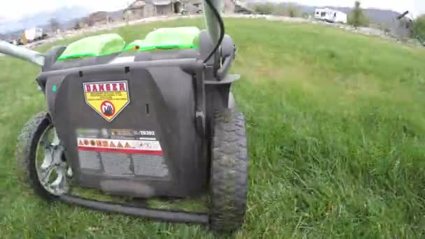 Mowing lawn with electric mower — Stock Video