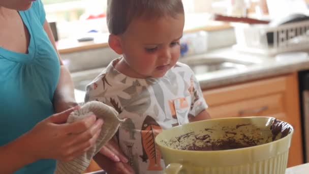 Woman making a cake with cute boys in the kitchen dolly shot — Stock Video