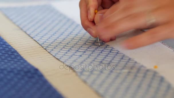 Woman putting pins on a sewing craft project — Stock Video
