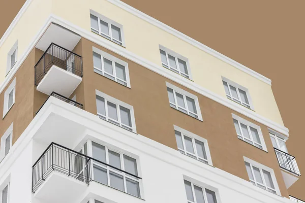 Apartment block under abstract brown sky. Isolated. Bottom view. Concept: life, couple, family, kids, independence. — Stock Photo, Image