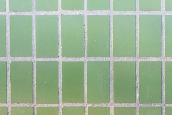 Facade of green mat ceramic tile texture. Geometric figures. Rectangles. — Stock Photo, Image