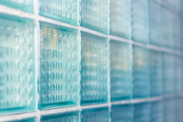 Decorative and glossy glass block window in blue as a texture or for background. The wall. Geometric background. — Stock Photo, Image