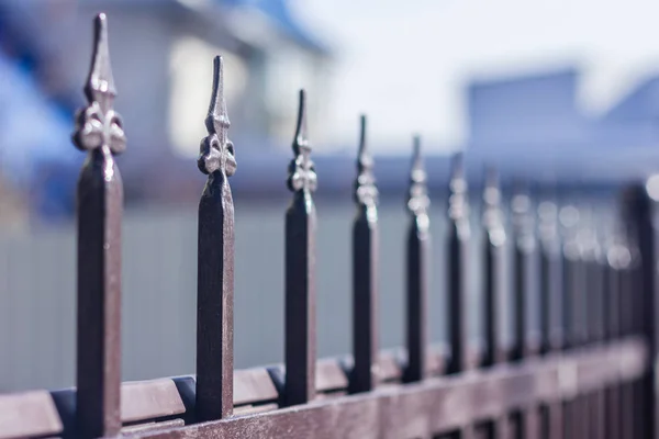 Metallic forged fence in the garden with spikes. — Stock Photo, Image
