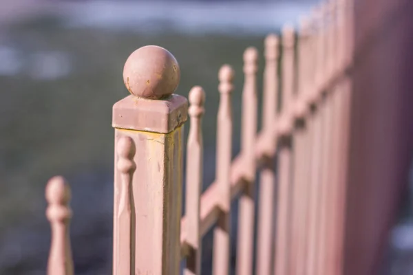 Metallic forged fence in the garden with balls and spikes. — Stock Photo, Image