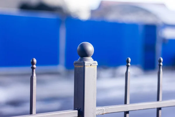 Metallic forged fence in the garden with balls and spikes. — Stock Photo, Image