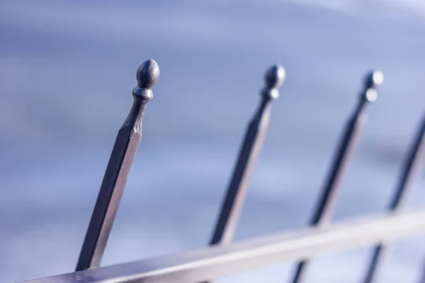 Metallic forged fence in the garden with balls and spikes. — Stock Photo, Image