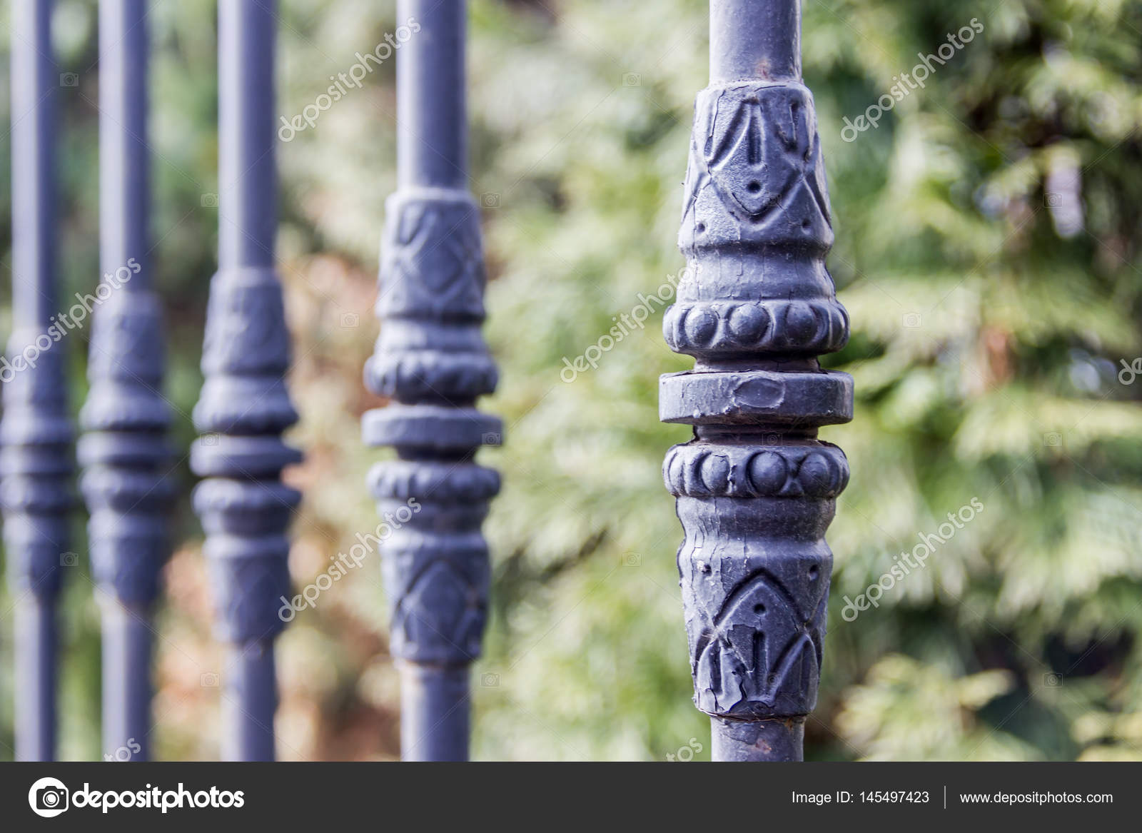Elements Of Black Metallic Forged Fence In The Garden With Spikes Elements Of Black Metallic Forged Fence In The Garden With Spikes Stock Photo