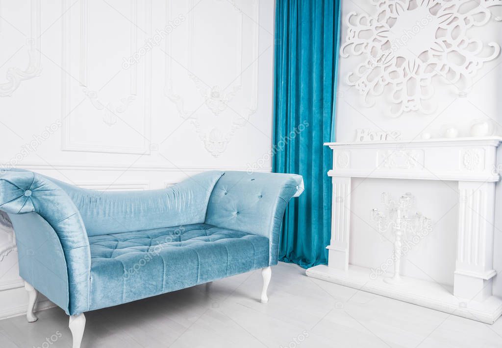 Blue sofa in white interior and gray floor. Venetian style. Decorative fireplace