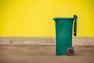 Gezici bir y zemin üzerine yeşil plastik çöp konteyner