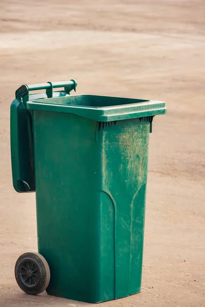 Contenedor de basura de plástico verde sobre ruedas se encuentra en el suelo. Ab — Foto de Stock