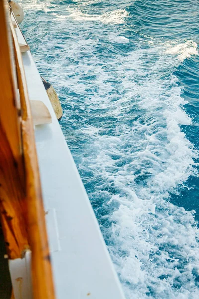 A fragment of the tourist yacht floats along the turquoise sea w Stock Photo