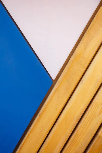 Fragment of the wall from the wooden beams light color with blue Royalty Free Stock Images