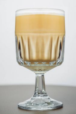 Cam fincan kahve beyaz zemin üzerine krem yakın çekim ile. Kap