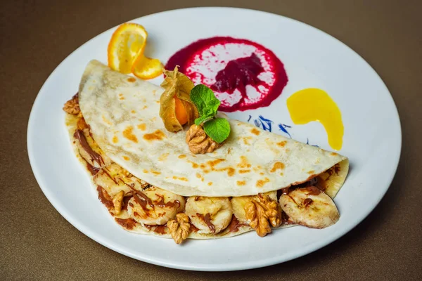 Piadina with bananas, nuts and chocolate paste with a flavor of Stock Image