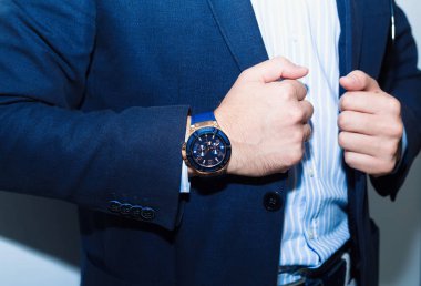 İşadamı uymak yakın çekim. Moda aksesuarları elleri ile rahat bez elbiseli genç işadamı yakışıklı modeli adam portresi