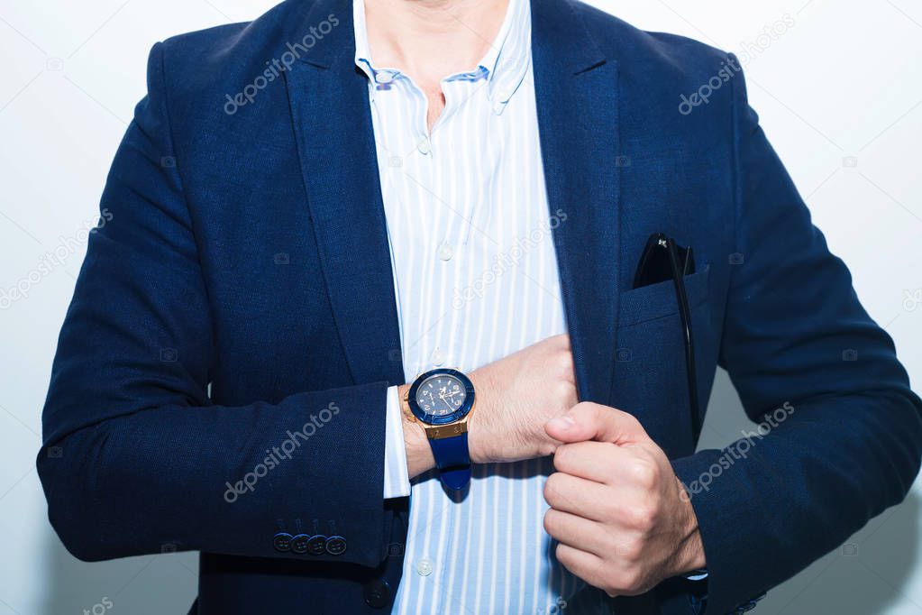Businessman in suit close-up.Fashion portrait of young businessman handsome model man in casual cloth suit with accessories on hands