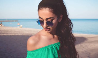 Manken kızla mutlu kız açık portre gülümseyen uzun kıvırcık saçları açık plaj portrait.young mutlu tropikal deniz ve plaj arka planda,