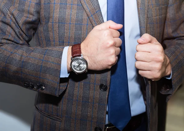 Cheerful young man in suit is preparing for an appointment. He is standing and touching his jacket.Man in suit. — Stock Photo, Image