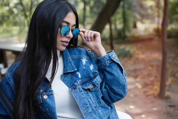 Primer plano estilo de vida retrato de moda de la joven mujer hipster con estilo caminando por la calle, usando jeans traje de moda —  Fotos de Stock