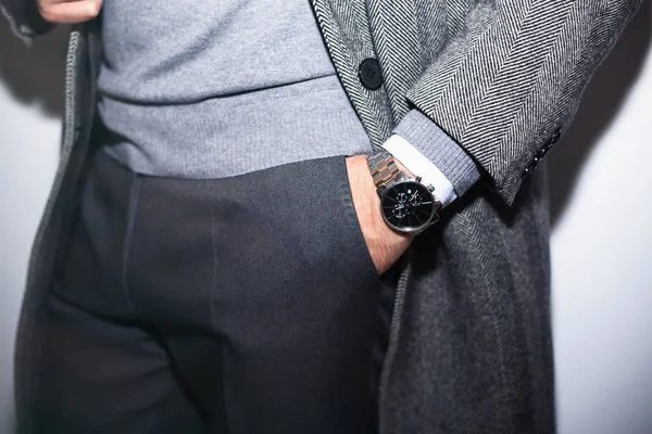 Closeup fashion image of luxury watch on wrist of man.body detail of a business man.Man's hand in wool blue jacket,in dark blue pants pocket closeup.Casual outfit. Tonal in a business suit close up — Stock Photo, Image