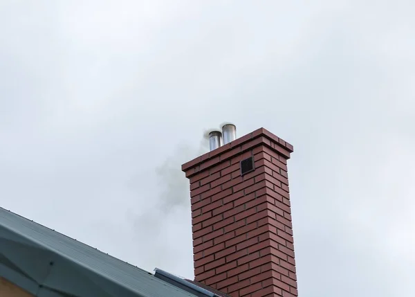 House chimney with flying smoke — Stock Photo, Image
