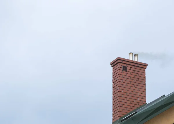 Καμινάδα σπιτιού με ιπτάμενα καπνού — Φωτογραφία Αρχείου