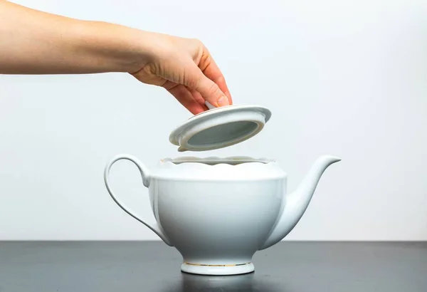 Elegant porcelain white jug and woman hand — Stock Photo, Image