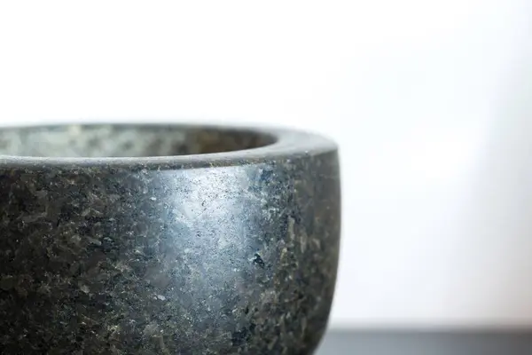 Granite mortar standing on kitchen table — Stock Photo, Image