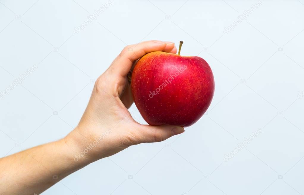 Apple holding by woman hands in close up