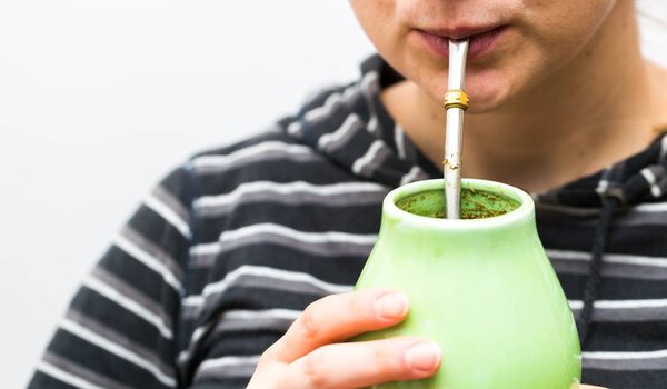 Unrecognizable woman drinking yerba mate