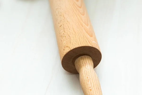 Close up of rolling pin lying on wooden table — Stock Photo, Image