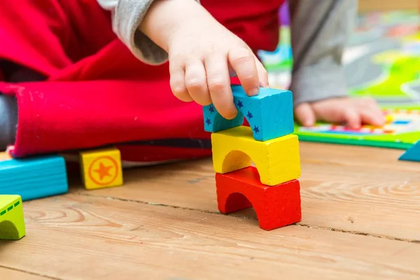 Small boy playing with wooden blocks — Stock Photo, Image