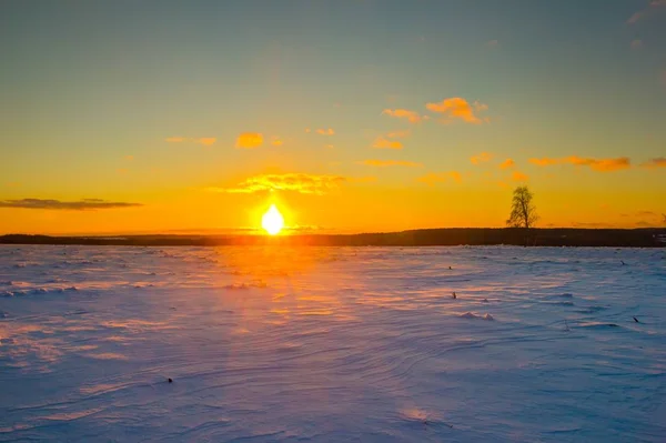 Sunset over winter snow fields — Stock Photo, Image