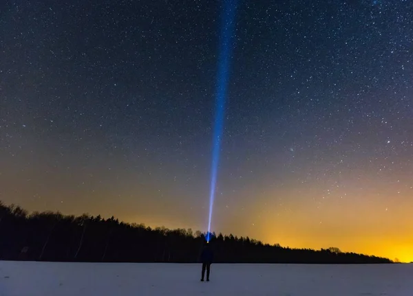 Night landscape with man with flashlight — Stock Photo, Image