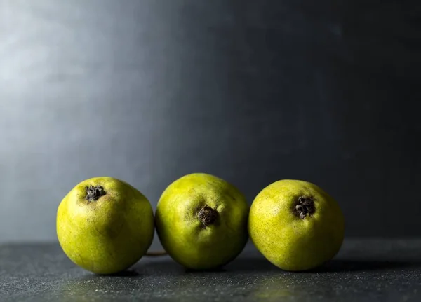 Green pears lying on dark background — Stock Photo, Image