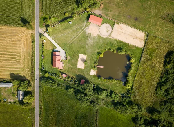 Top down drone landscape with buildings on fields. Farm from above.