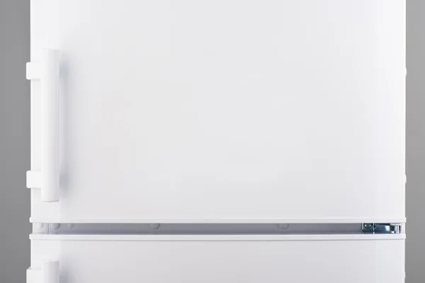 White refrigerator on gray — Stock Photo, Image