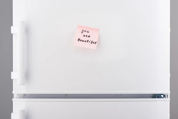 You are beautiful note on pink paper on white refrigerator — Stock Photo, Image