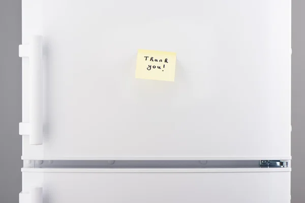 Obrigado nota no papel pegajoso amarelo no refrigerador branco — Fotografia de Stock