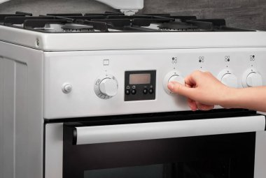 El beyaz mutfak gaz sobası gri üzerine açma