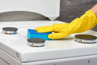 Sarı eldiven mavi sünger ile soba beyaz temizlik el 