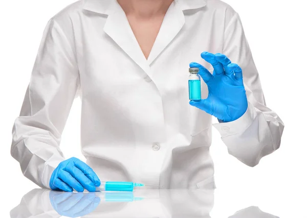 Doctor holding syringe and ampoule with blue drug — Stock Photo, Image