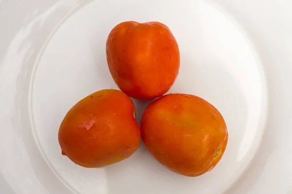 Three Orange Tomato on White Plate — Stock Photo, Image