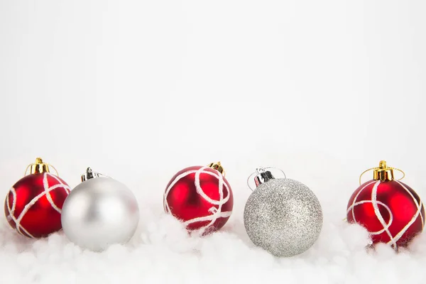 Red and silver Christmas balls on abstract background