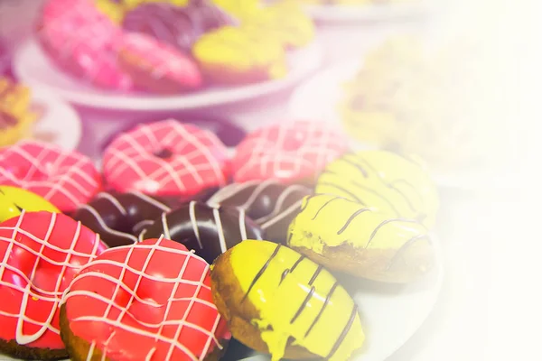 Assorted colored donuts with chocolate frosted — Stock Photo, Image