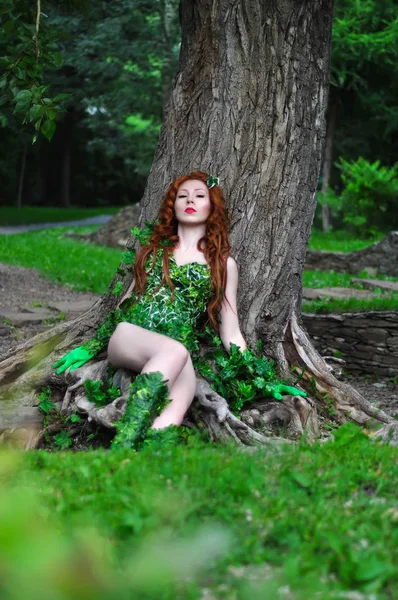 Young beautiful red-haired girl in the image of the comic book poison ivy