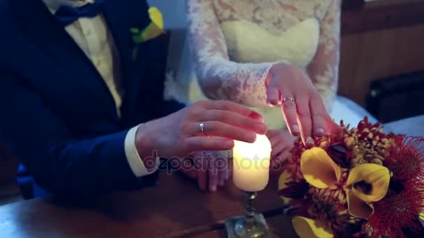 On a wedding day groom puts a wedding ring on finger of a bride. Bride puts a ring on finger of a groom — Stock Video